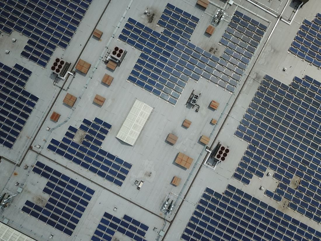 Aerial view of solar panels covering a large commercial rooftop
